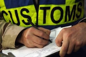 800px US Navy 061209 N 8148A 067 A customs border clearance agent assigned to Navy Customs Battalion Romeo keeps record of each inspection