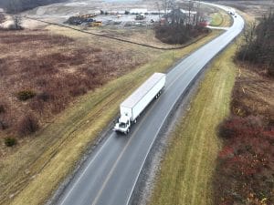 Autonomous tractor pulling a trailer down a highway