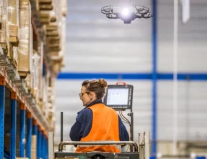 Warehouse worker working together with a drone
