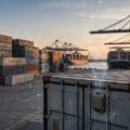Container with a tracking device, a shipping yard, and a container ship